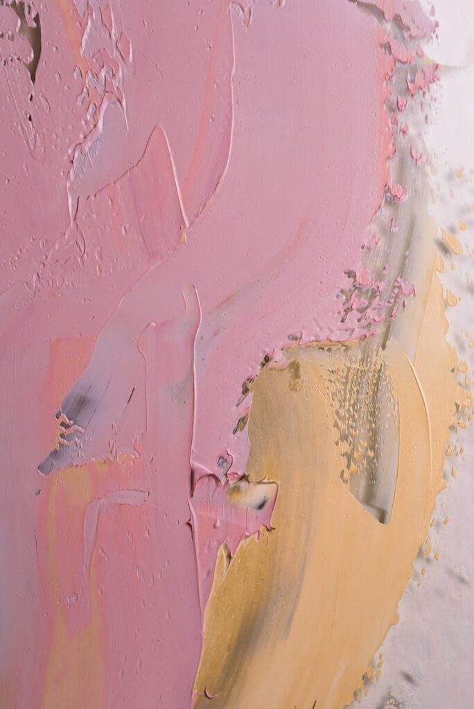 Dynamic abstract painting featuring bold pink and gold textures for creative inspiration.